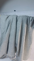 Black and ivory check cashmere blanket – Draped view