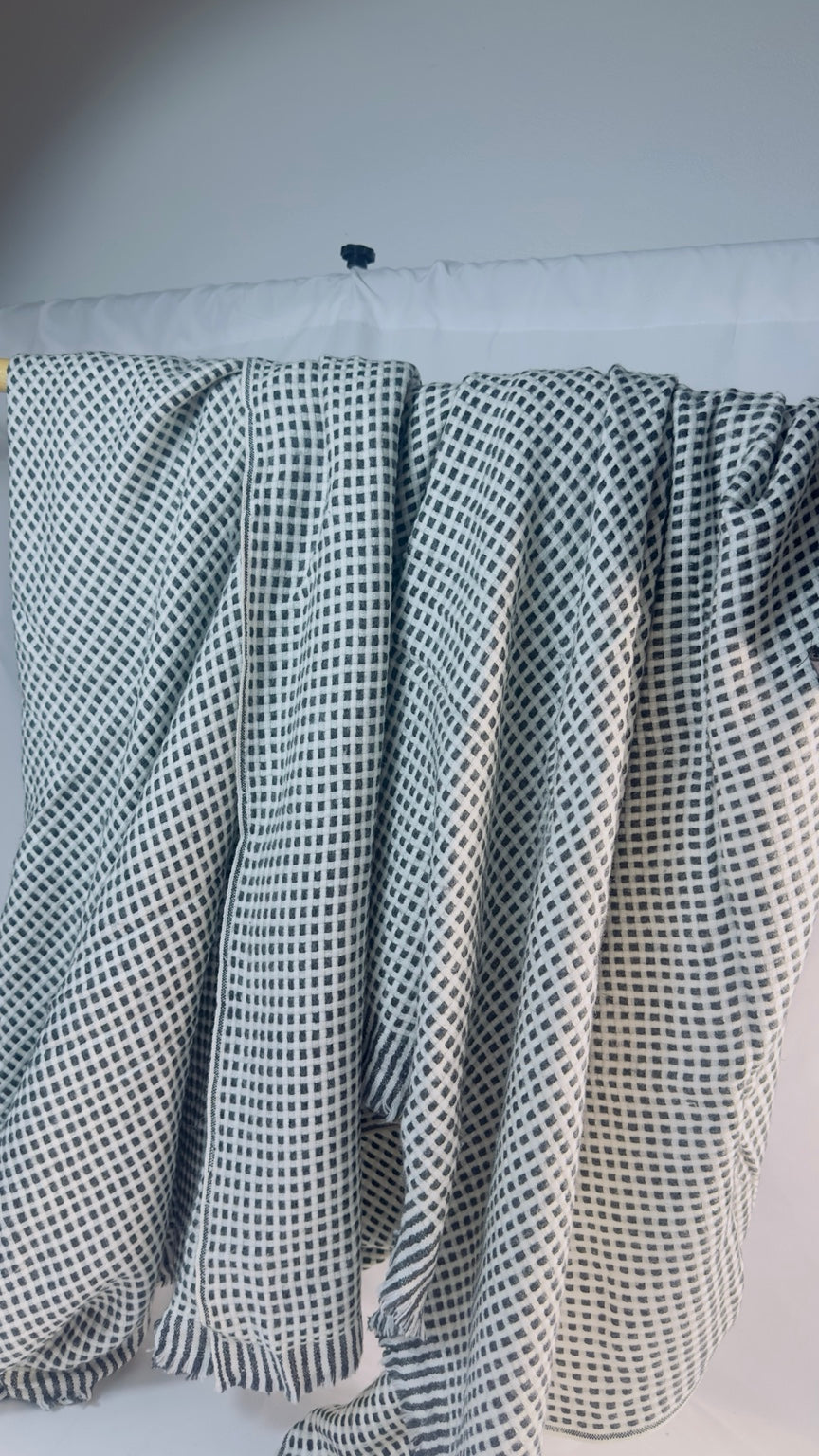Black and ivory check cashmere blanket – Draped view