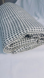 Black and ivory check cashmere blanket – Folded texture close-up