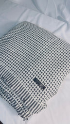 Black and ivory check cashmere blanket – Folded label and fringe view
