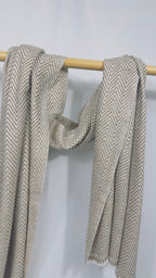 Beige herringbone cashmere scarf styled in an open double drape