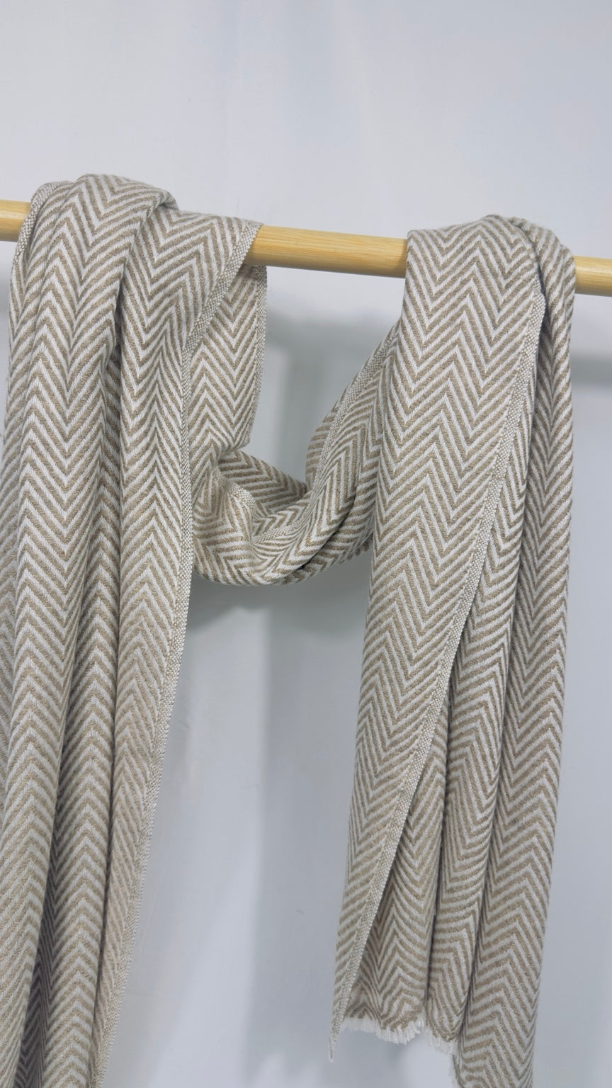 Beige herringbone cashmere scarf styled in an open double drape